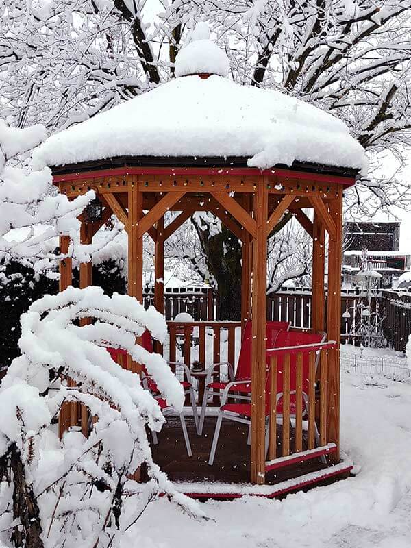 small wood gazebo with snow