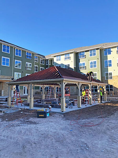 contractors working on the roof of a pergola