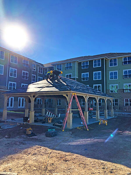 contractors working on the roof of a pergola