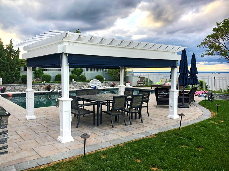 12x16 classic vinyl pergola next to a pool and outdoor furniture