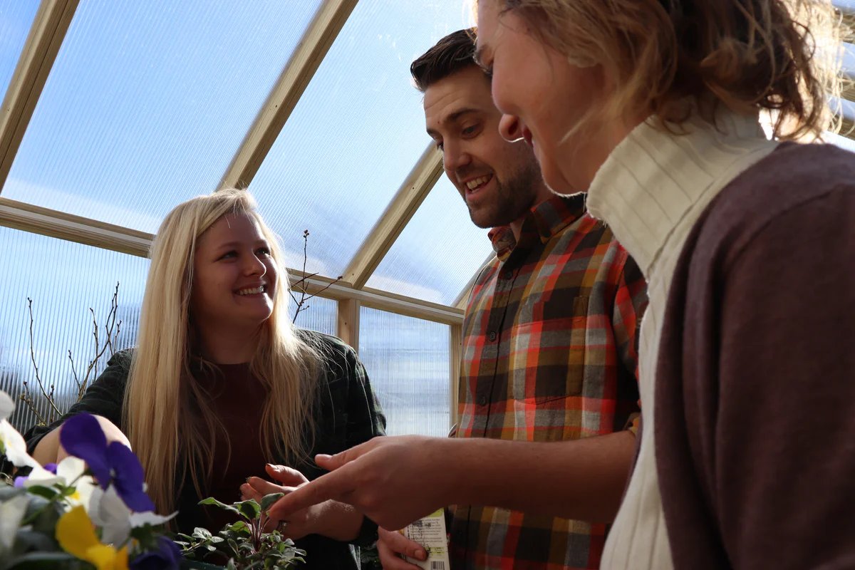 People gardening inside an EZ Greenhouse